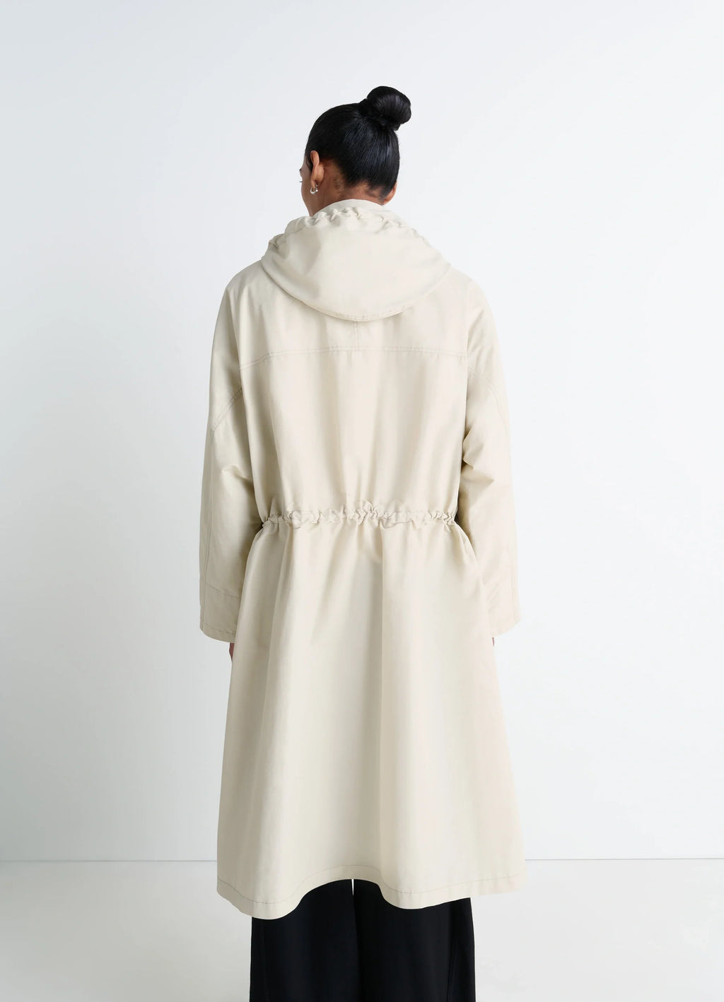 Lemaire Utility Raincoat in Beige Linen Cotton Blend, model shot, back shoulder view hooded waist drawstring