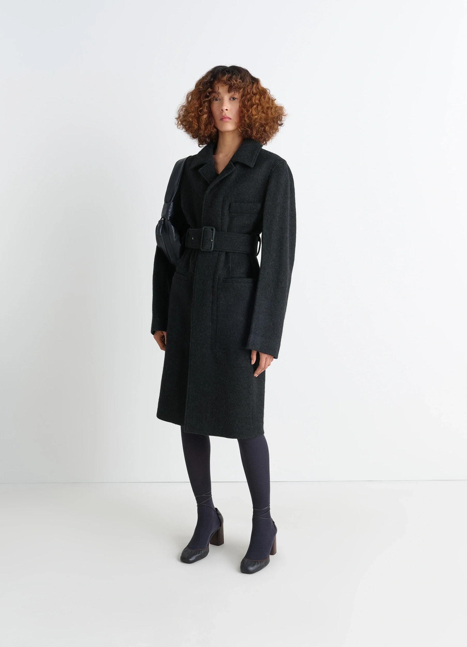 Belted tailored coat in deep charcoal wool alpaca, model shot, front view belted, tailored fit