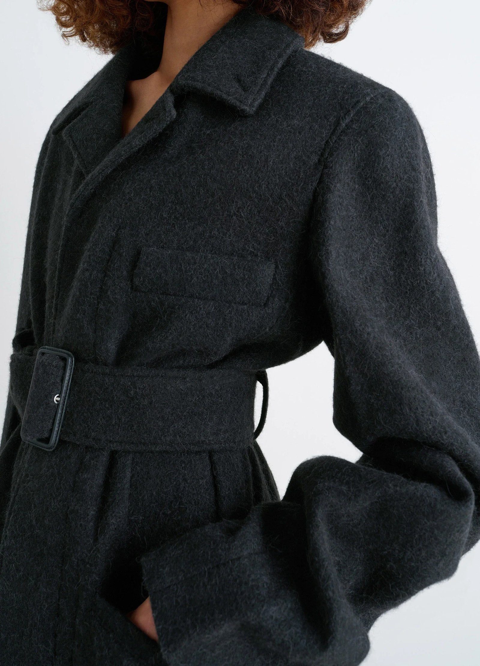 Belted tailored coat in deep charcoal wool alpaca, model shot, detail shot textured fabric relief