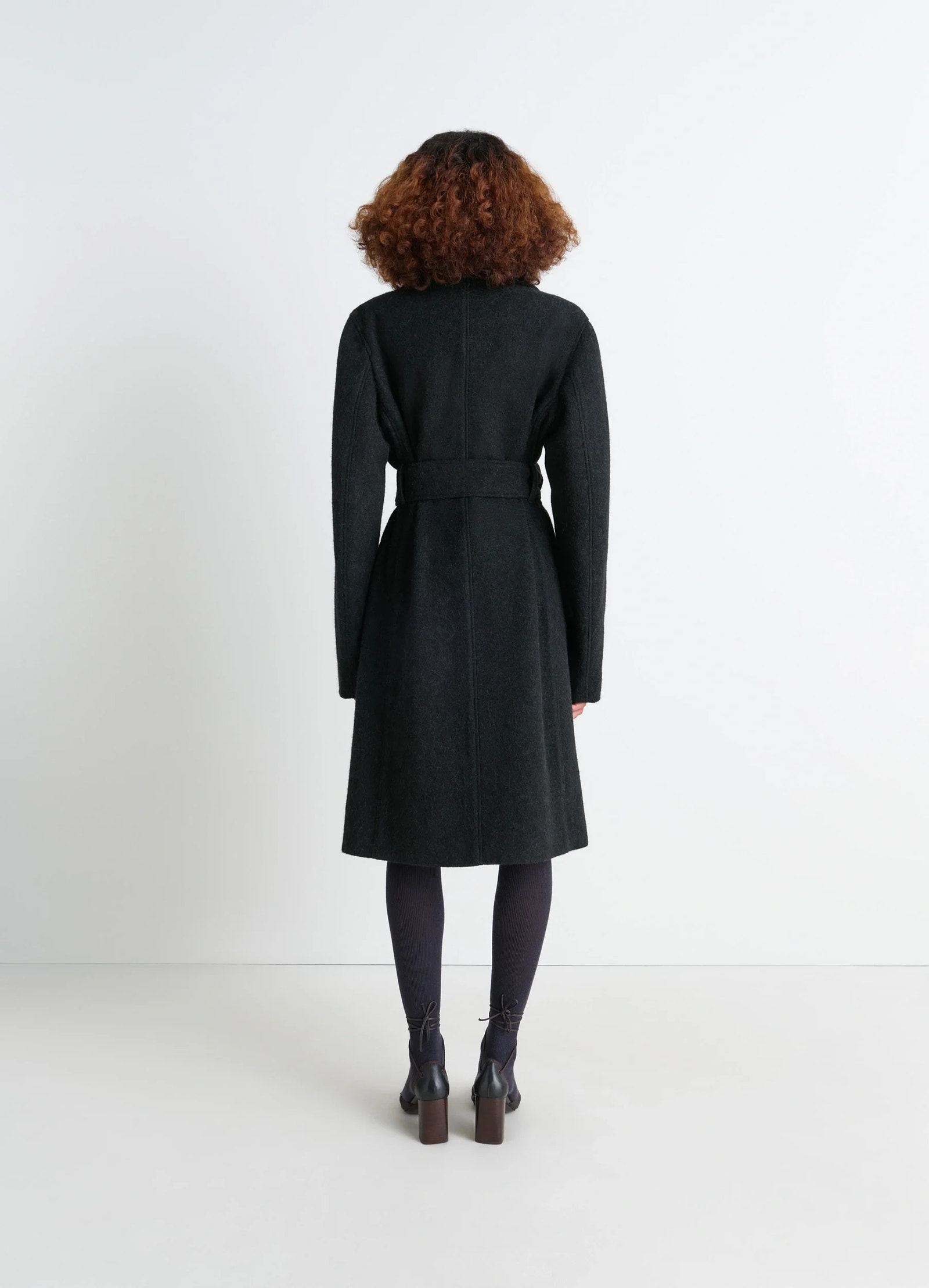 Belted tailored coat in deep charcoal wool alpaca, model shot, back view belted silhouette, straight back se