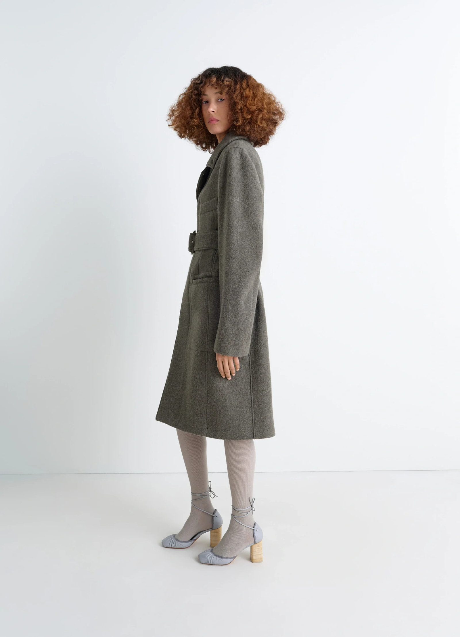 Belted tailored coat in wool and alpaca blend, model shot, side profile view structured silhouette