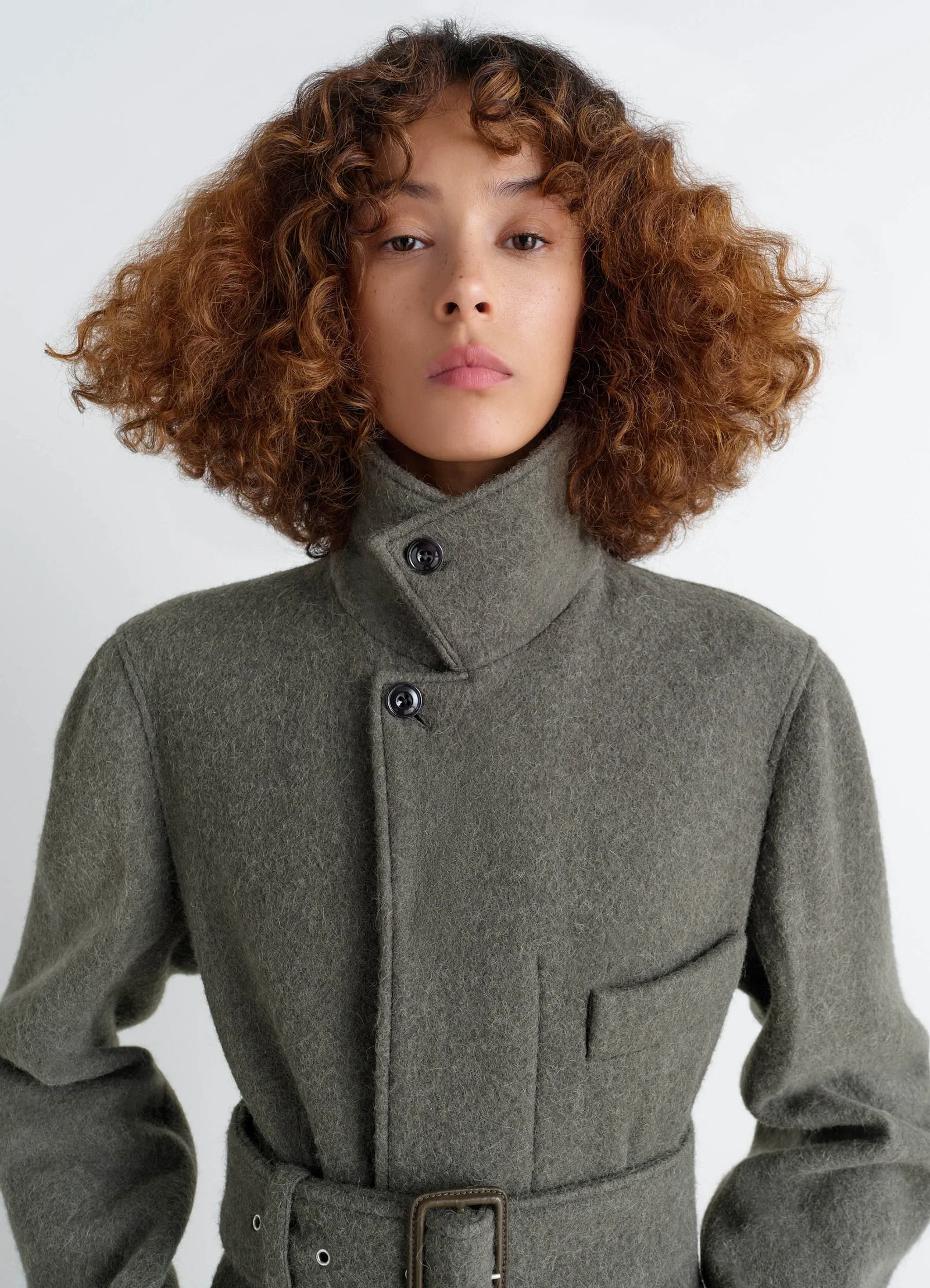 Belted tailored coat in wool and alpaca blend, model shot, close-up neck high collar, chest pocket