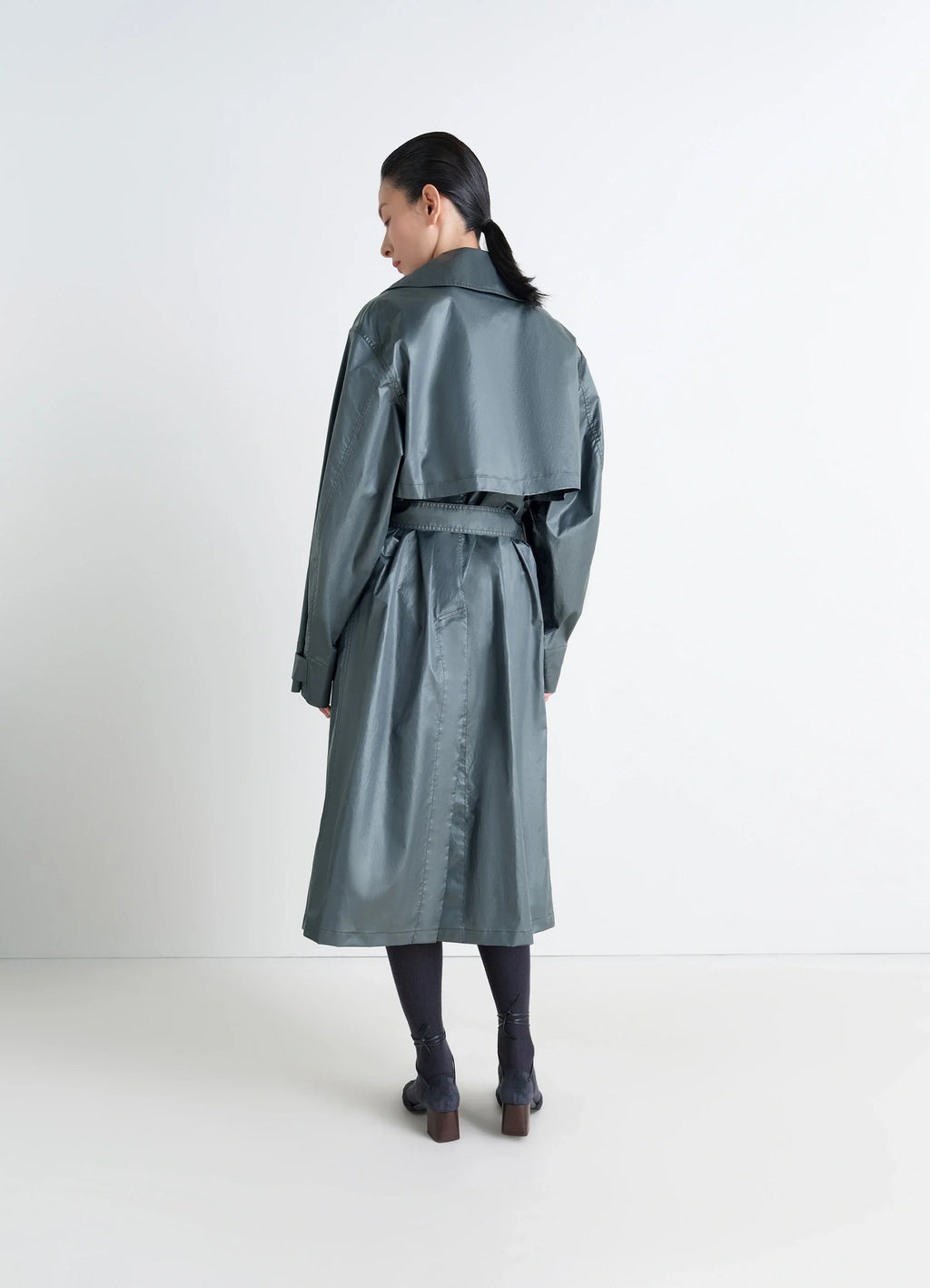 Oversized Trench Coat in Metallic Coated Cotton, model shot, back view vented hem, storm flap