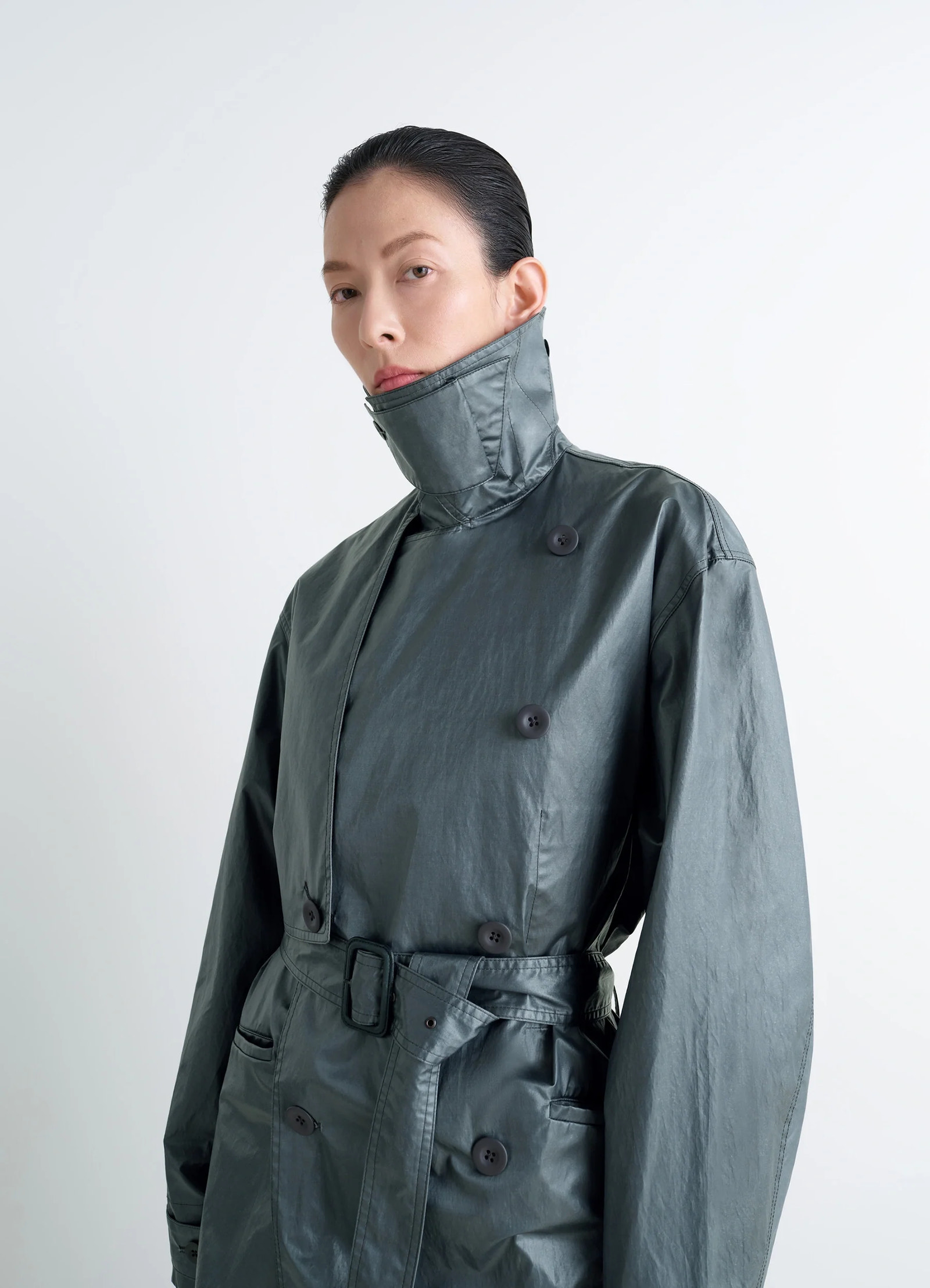 Oversized trench coat in metallic coated cotton, model shot, close-up collar view high collar detail