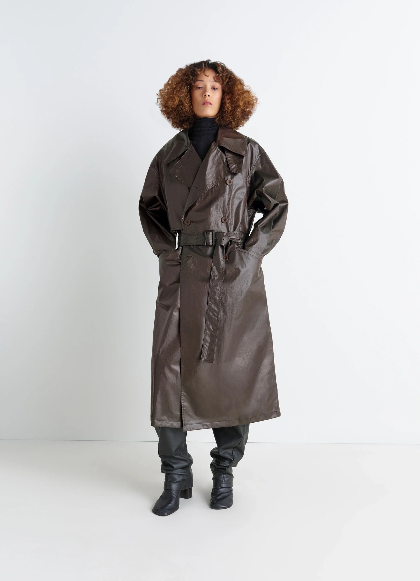 Oversized trench coat in metallic coated cotton, model shot, three-quarter view belted waist detail