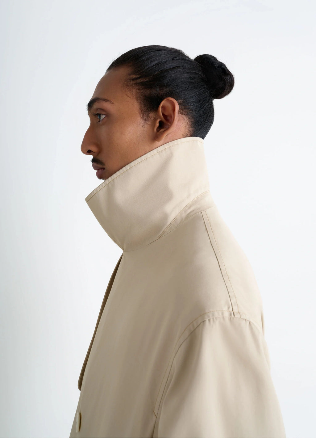 Ventile Trench Coat in Beige Ventile Cotton, model shot, profile view raised collar detail