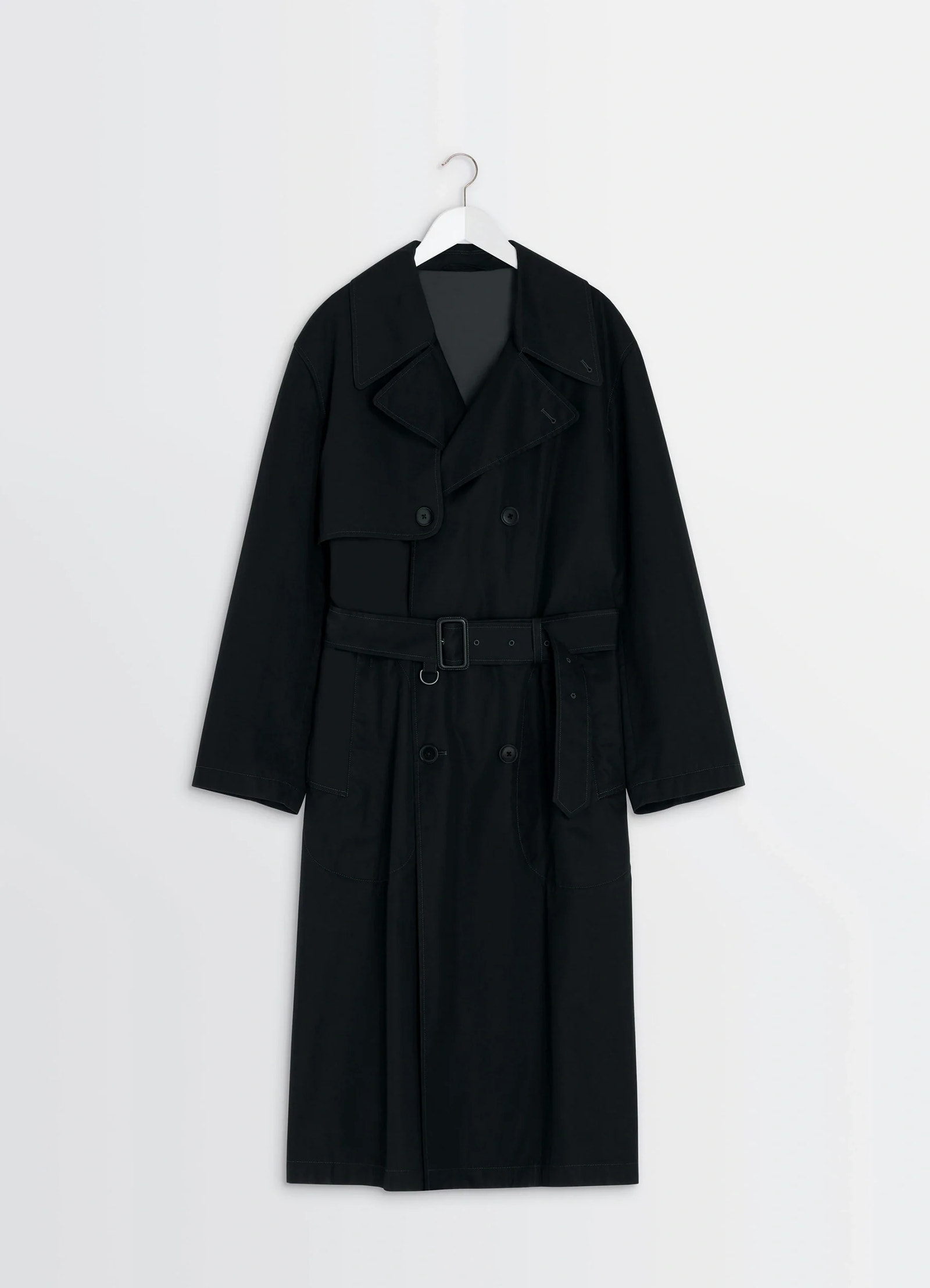 Ventile trench coat in black ventile cotton, product shot, hanging packshot view storm flap, belt loops