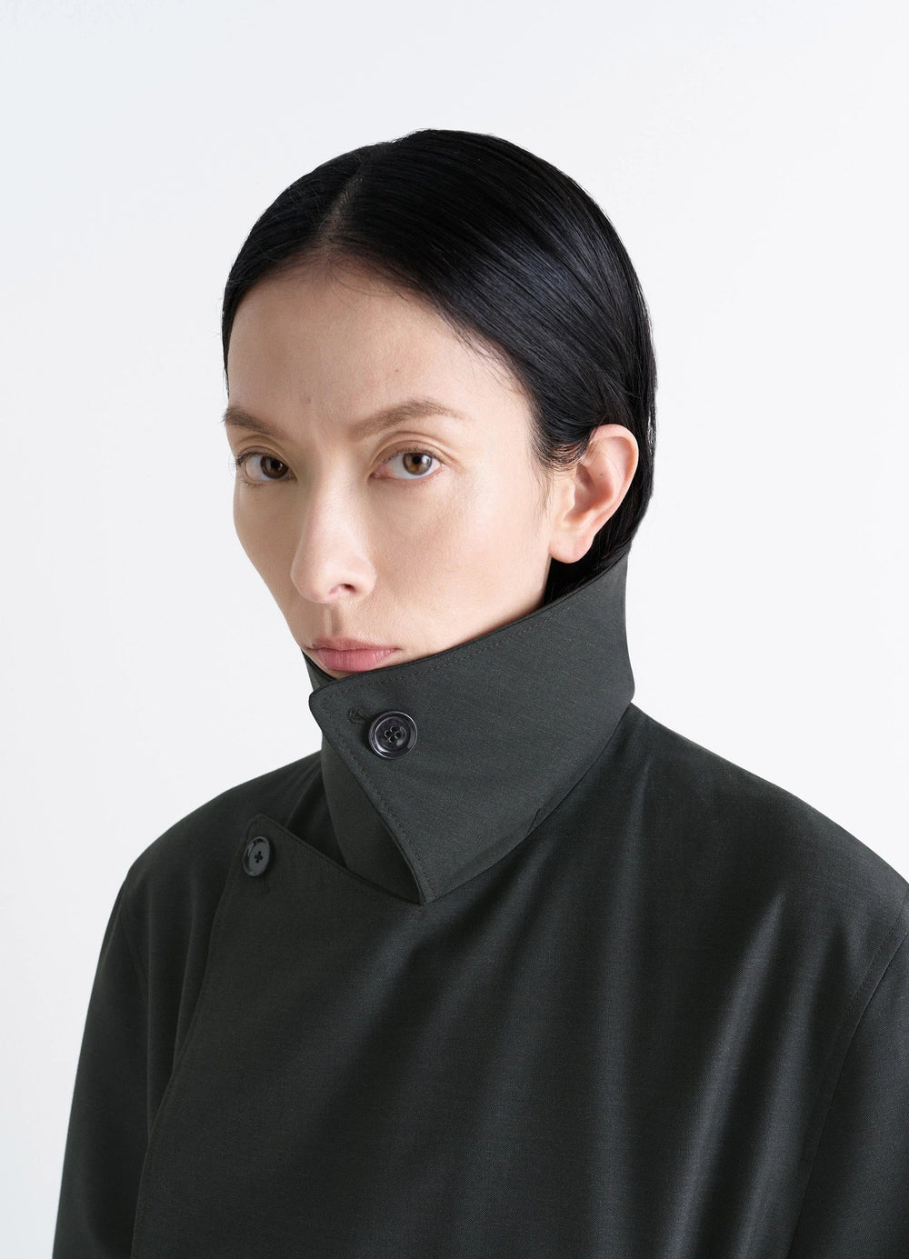Lemaire Trench Coat in Tropical Wool-Blend, model shot, close-up collar view high collar button detail