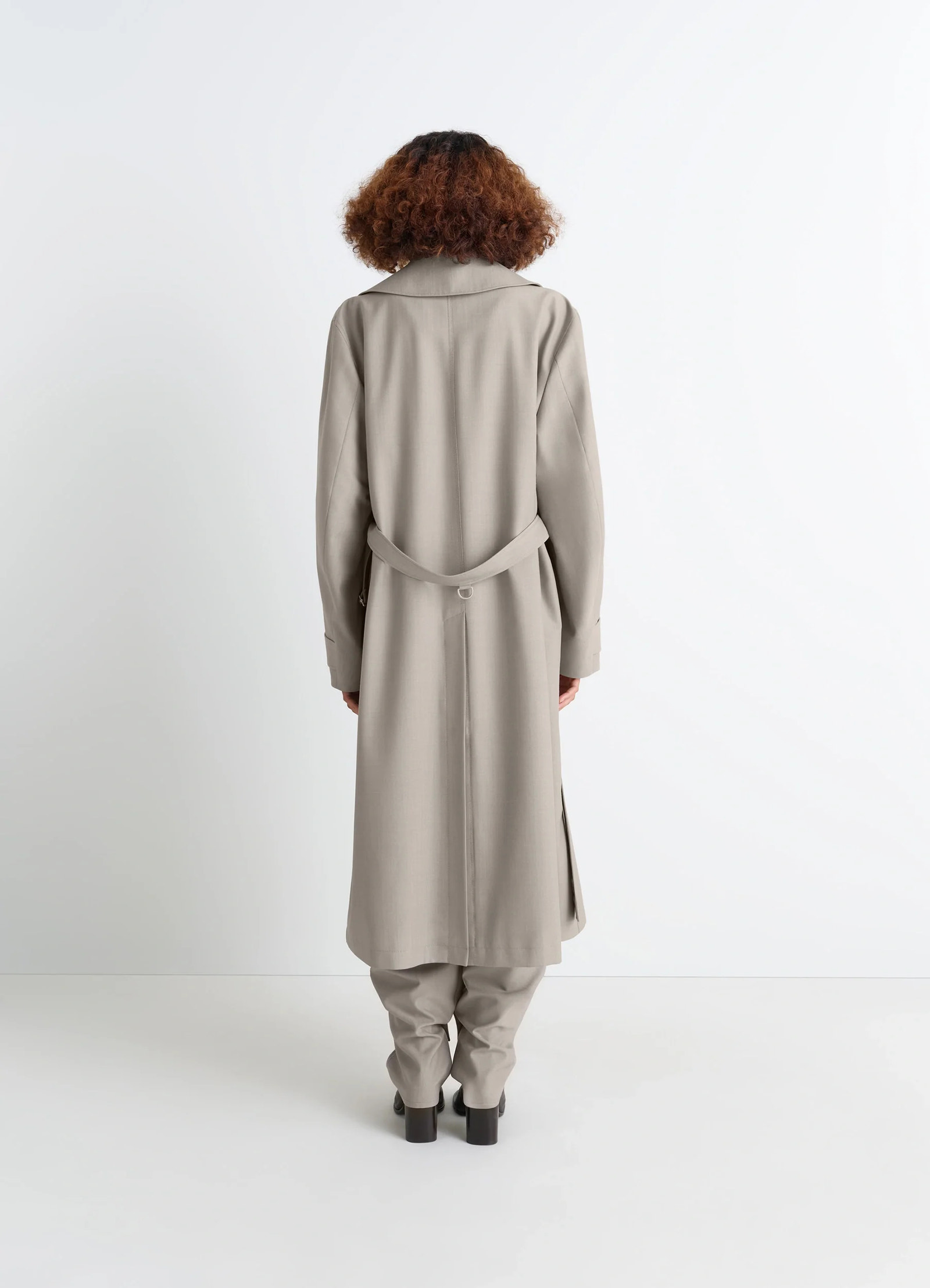 Lemaire trench coat in tropical wool-blend mottled, model shot, back view belted back, vented hem