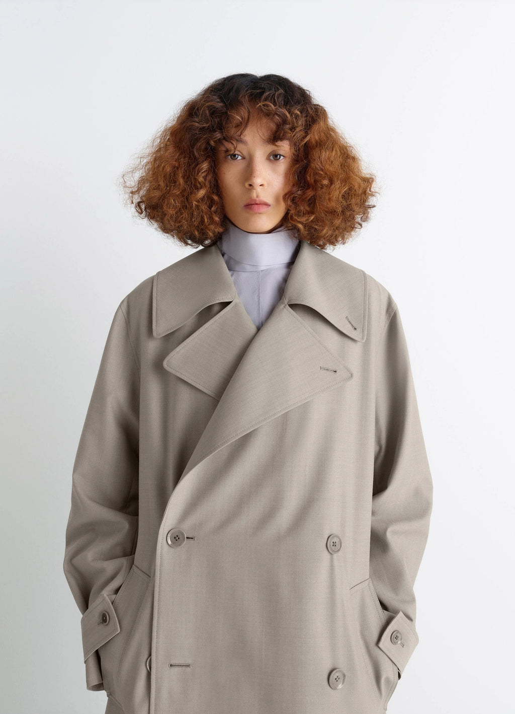 Lemaire Trench Coat in Tropical Wool-Blend Mottled, model shot, close-up view large lapels, double-breasted