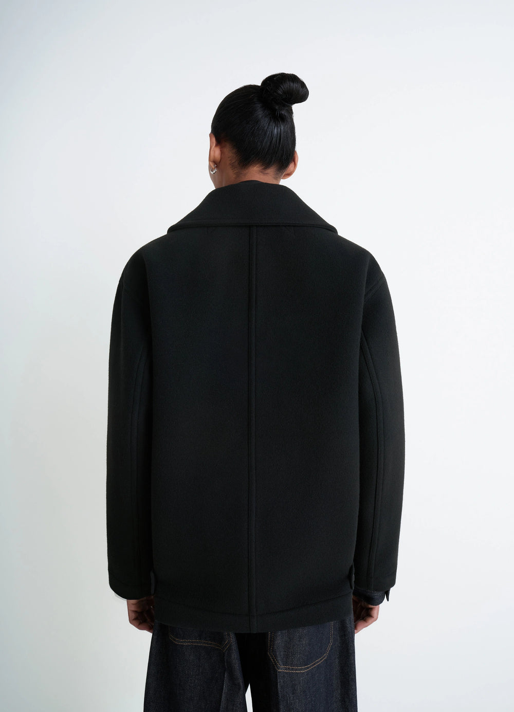 Lemaire Boxy Peacoat in Black Double-Faced Wool, model shot, rear back view high collar single vent