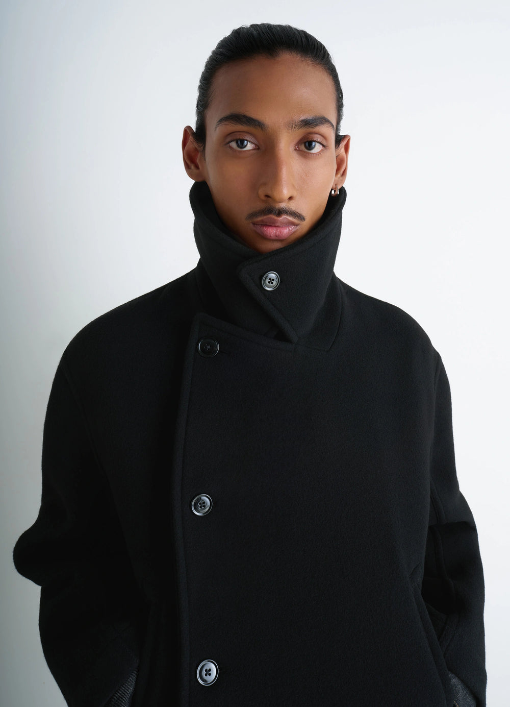 Lemaire Boxy Peacoat in Black Double-Faced Wool, model shot, close-up detail view high collar buttoned style