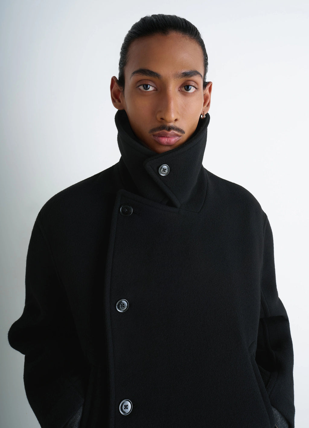 Lemaire Boxy Peacoat in Black Double-Faced Wool, model shot, close-up detail view high collar buttoned style