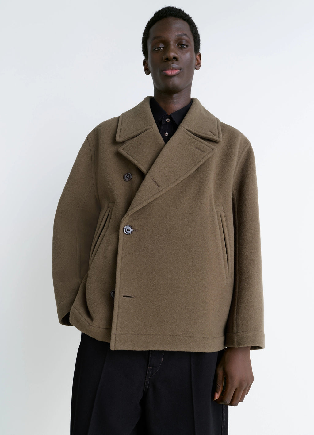 Lemaire Boxy Peacoat in Double-faced Wool, model shot, three-quarter view loose fit, lapel collar