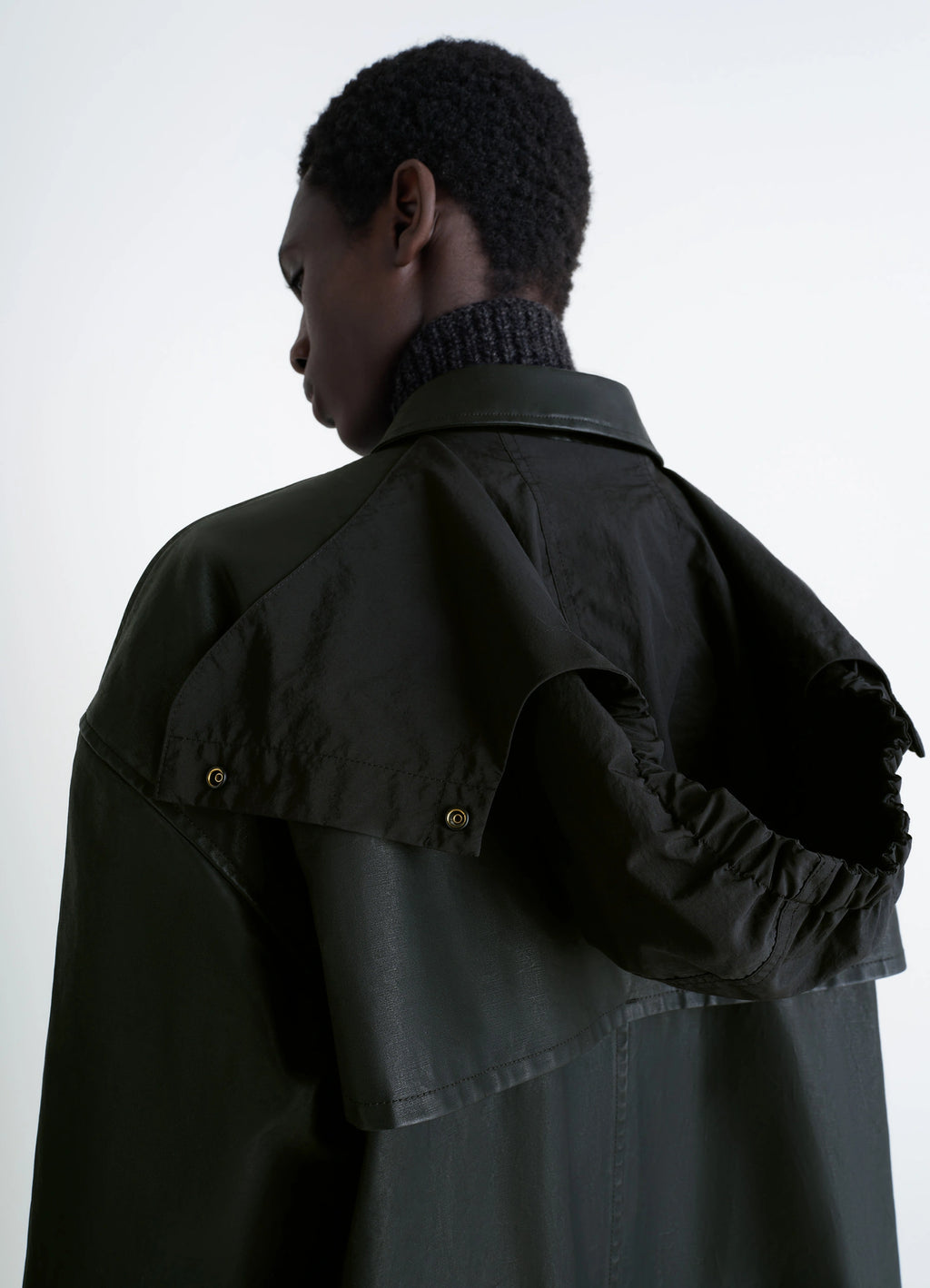 Hooded Raincoat in Water-repellent Resinated Cotton, model shot, back view with hood rear flap detail visible