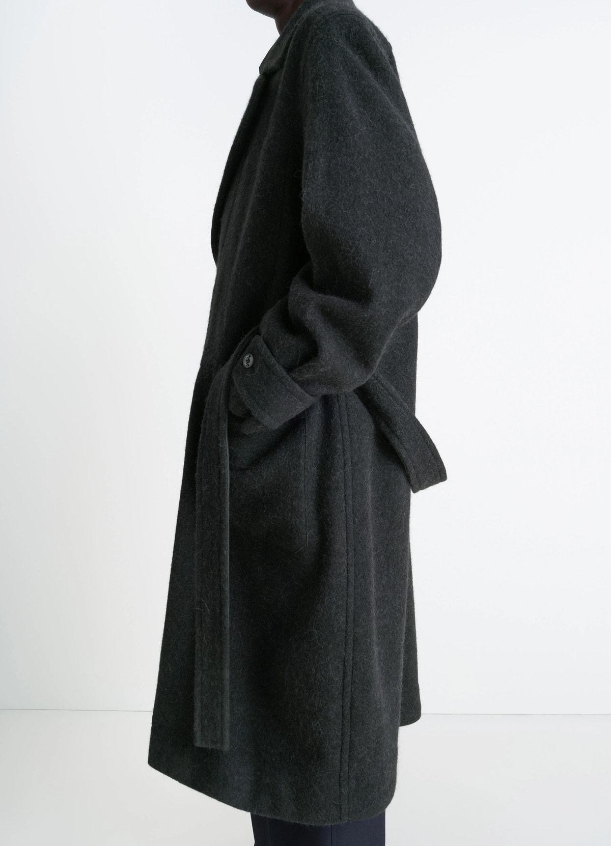 Soft coat in dark wool alpaca blend, model shot, side view belted waist, cuff detail