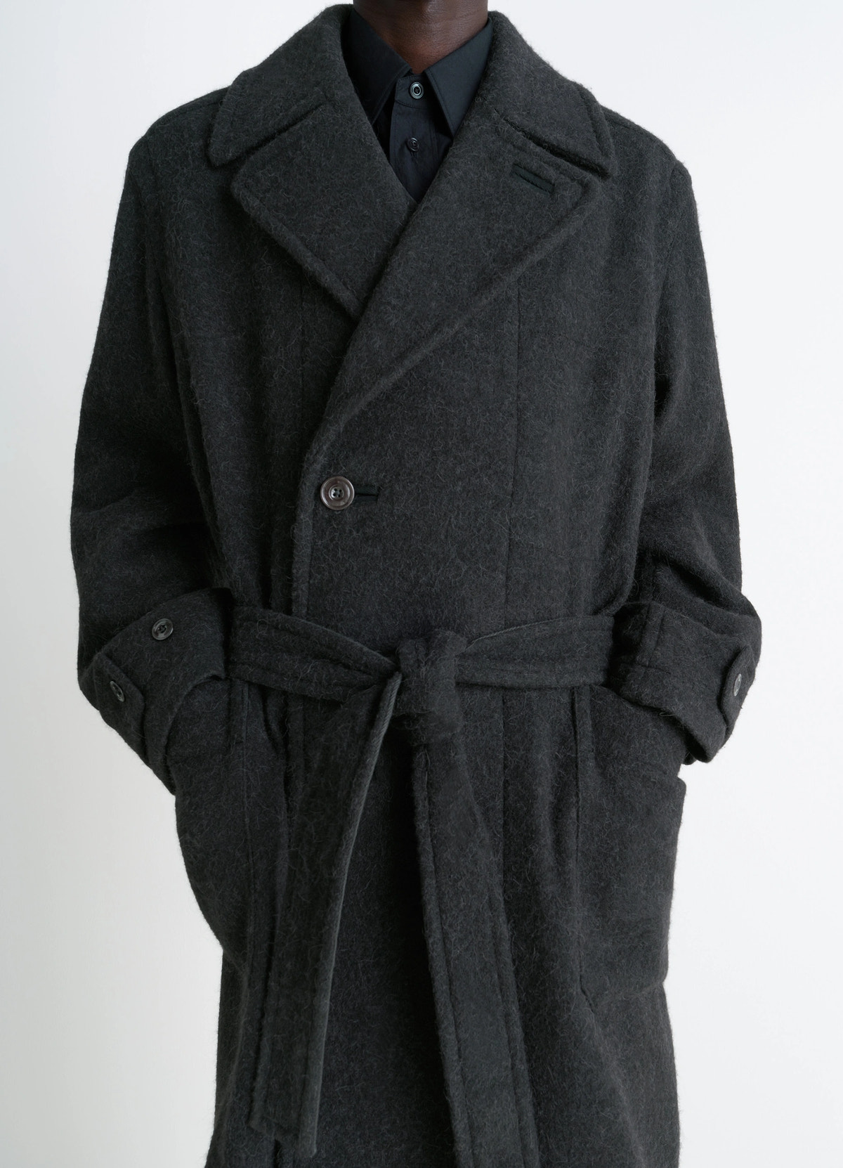 Soft coat in dark wool alpaca blend, model shot, waist-up view tied belt detail