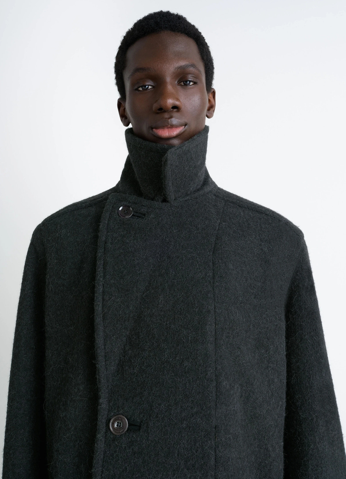Soft coat in dark wool alpaca blend, model shot, high-neck detail view raised collar design
