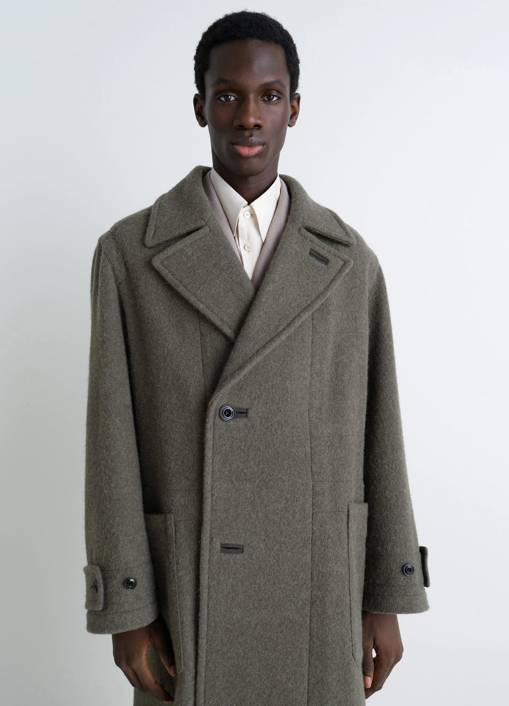 Lemaire Soft Coat in Wool and Alpaca Blend, model shot, close-up front view notched lapels, patch pockets