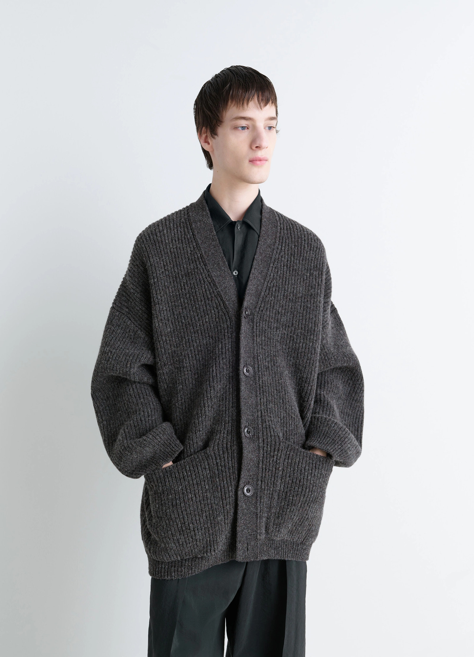 Ribbed shetland wool cardicoat in dark heather shetland wool, model shot, three-quarter view ribbed texture, cuffed sleeves
