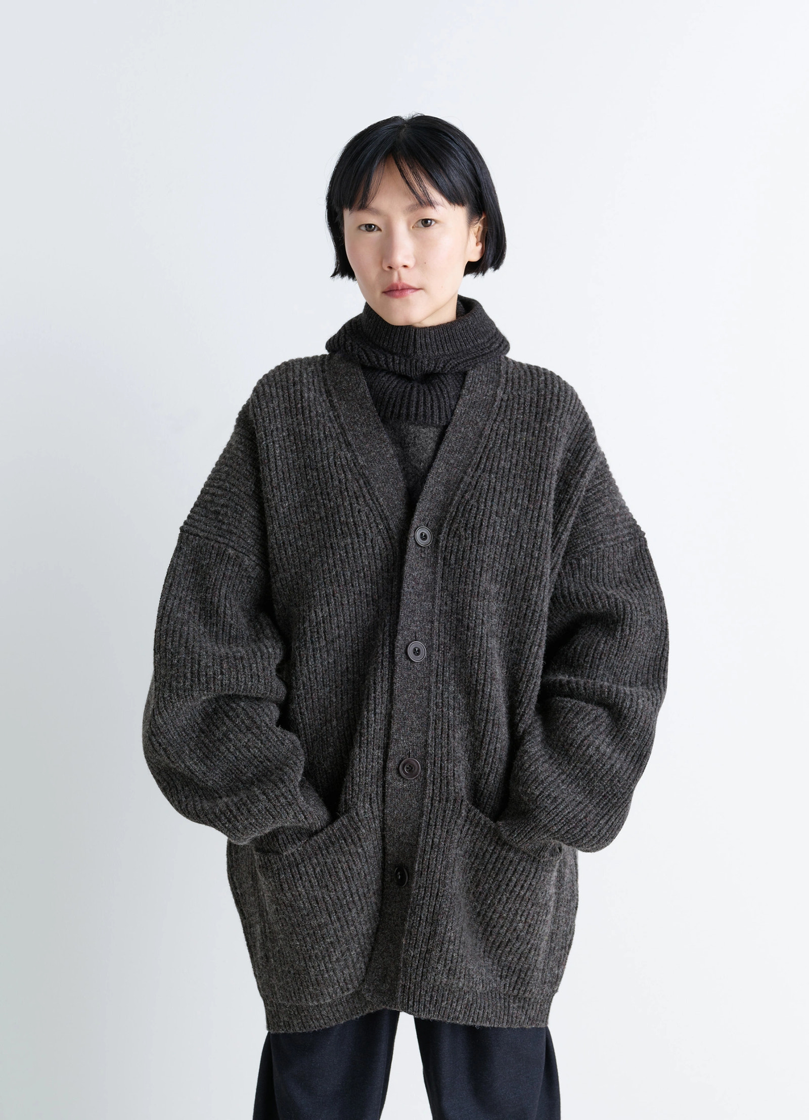 Ribbed shetland wool cardicoat in dark heather shetland wool, model shot, close-up front view deep v-neck, large buttons