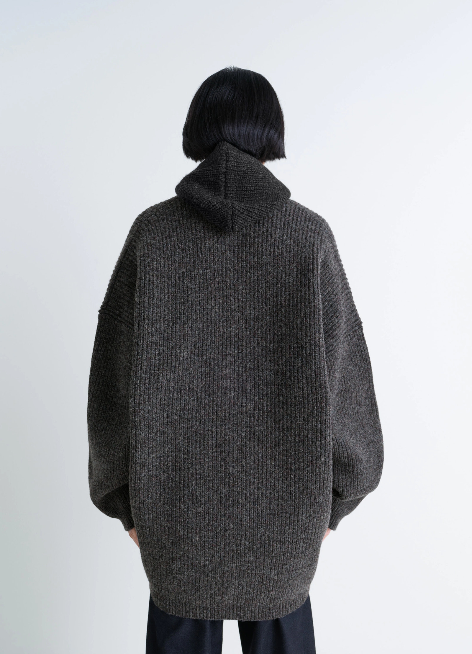 Ribbed shetland wool cardicoat in dark heather shetland wool, model shot, rear view hooded back detail