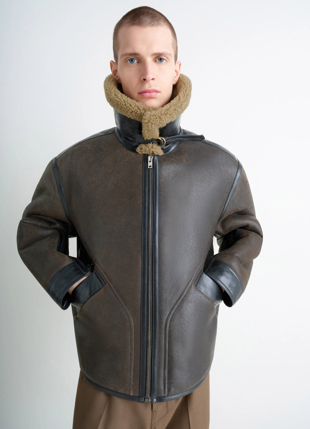 Shearling Coat in Contrasting Leather Trim, model shot, close-up view hands in pockets