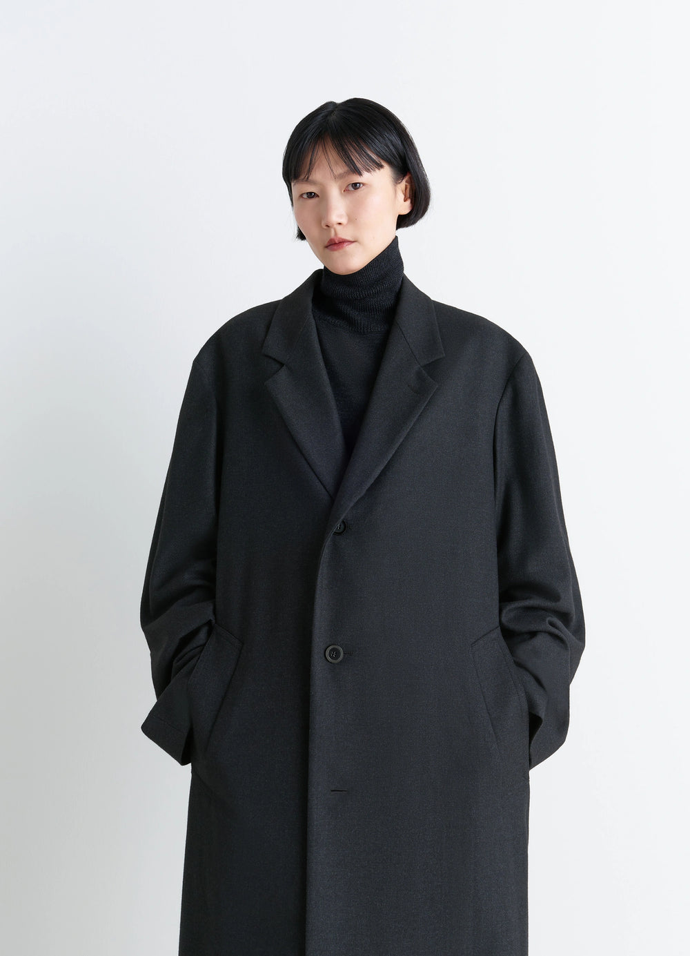 Lemaire Soft Chesterfield Coat in Light Cashmere-Blend, model shot, close-up portrait view buttoned front, hand in pocket