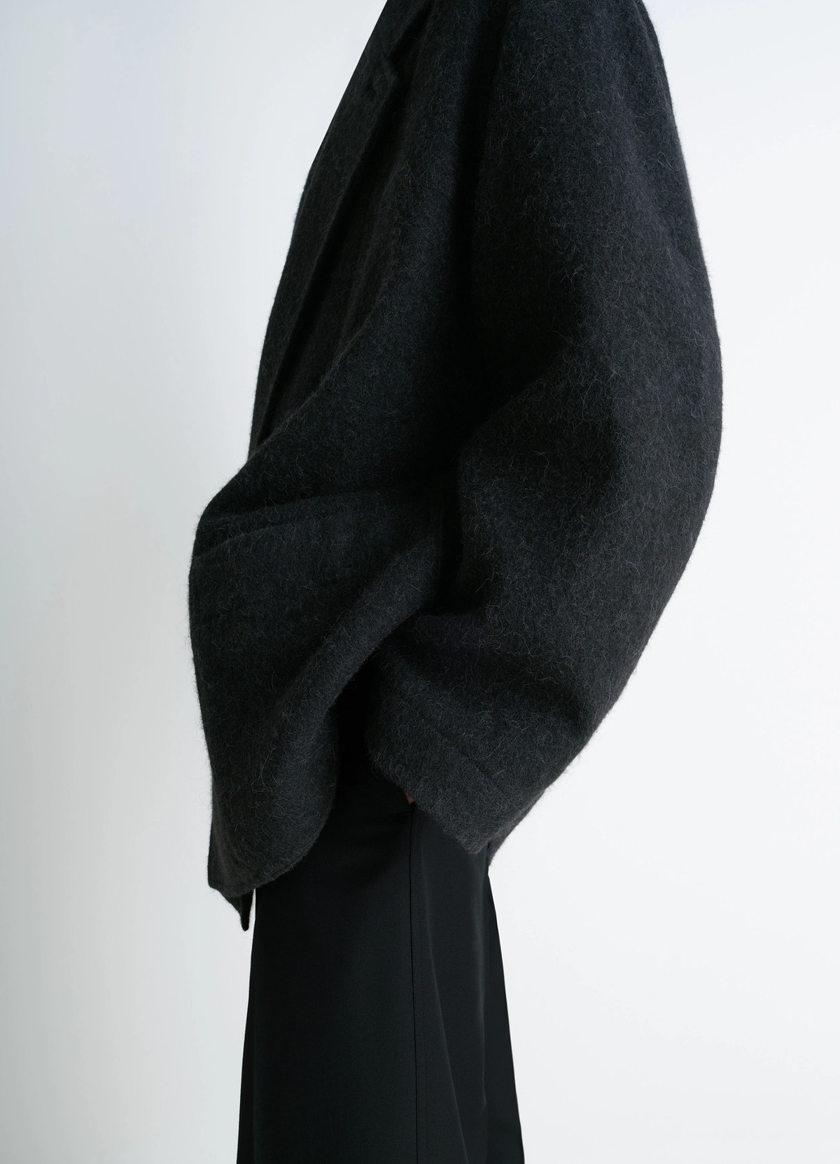 Felt wool jacket in wool and alpaca blend, model shot, left side view draped shoulder detail