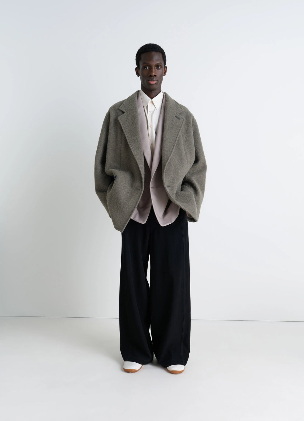 Lemaire Felt Wool Jacket in Olive Wool and Alpaca, model shot, three-quarter view unlined with ribbon trim