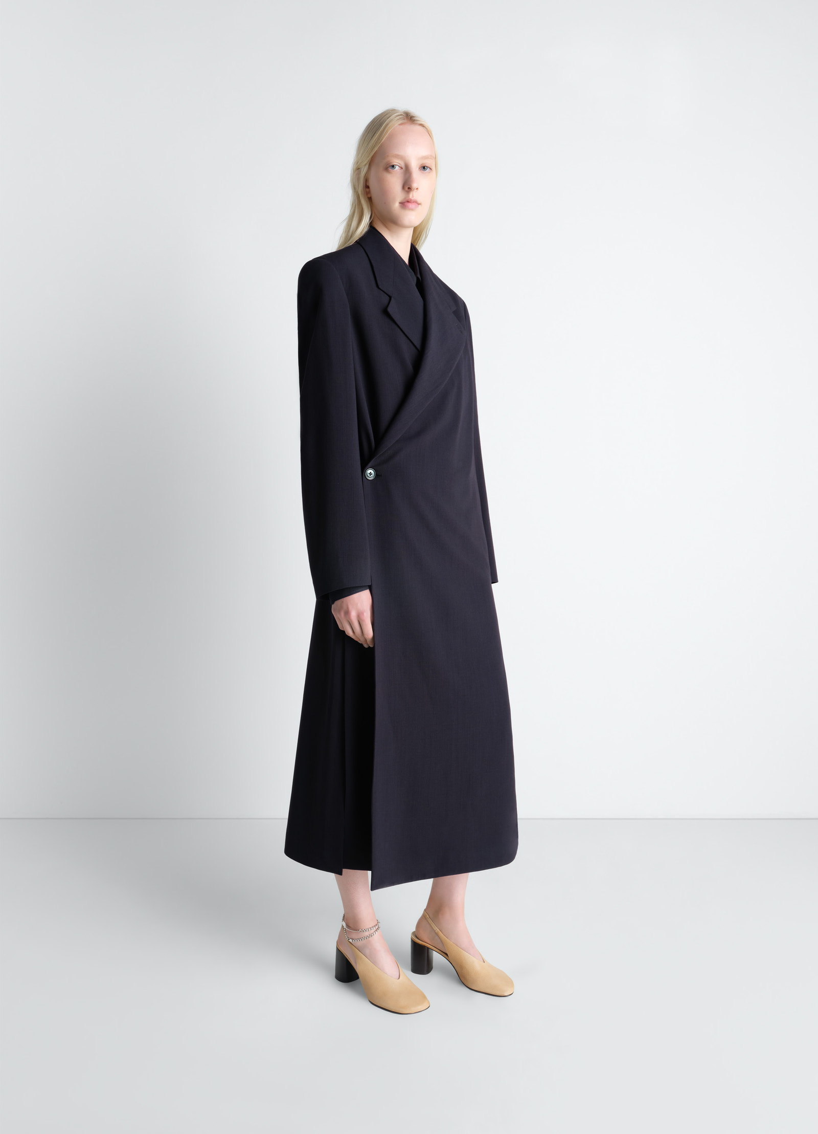 Wrap over coat in wool crepe in dark wool crepe, model shot, 3/4 front view elongated silhouette