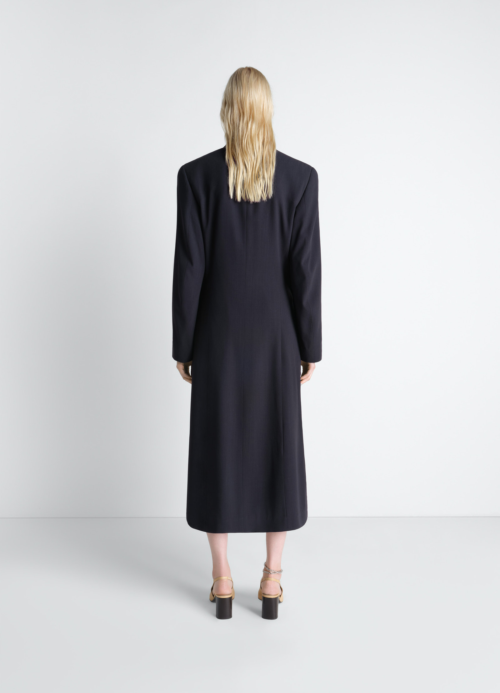 Wrap over coat in wool crepe in dark wool crepe, model shot, back view structured shoulder design