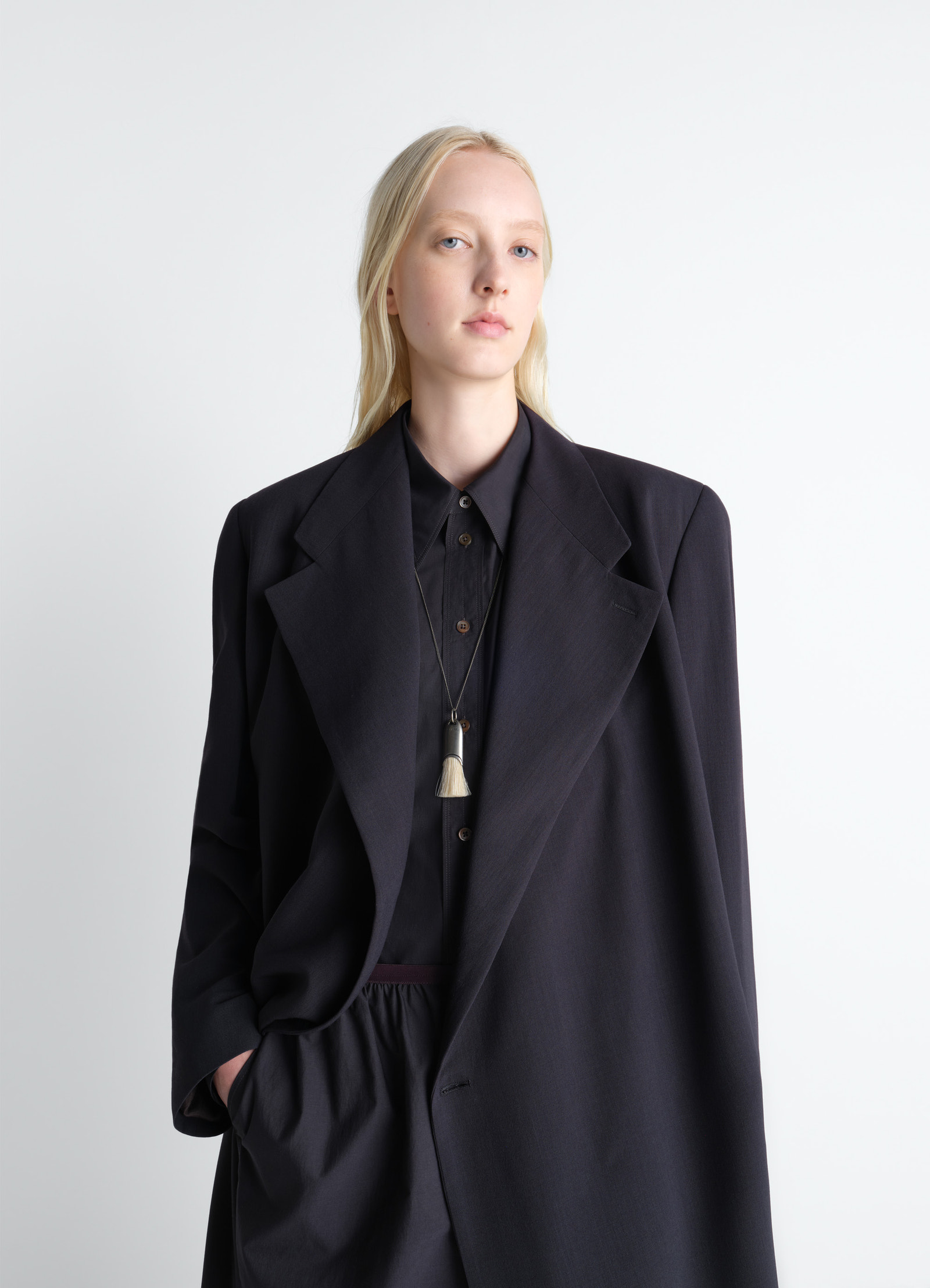 Wrap over coat in wool crepe in dark wool crepe, model shot, side view oversized collar detail