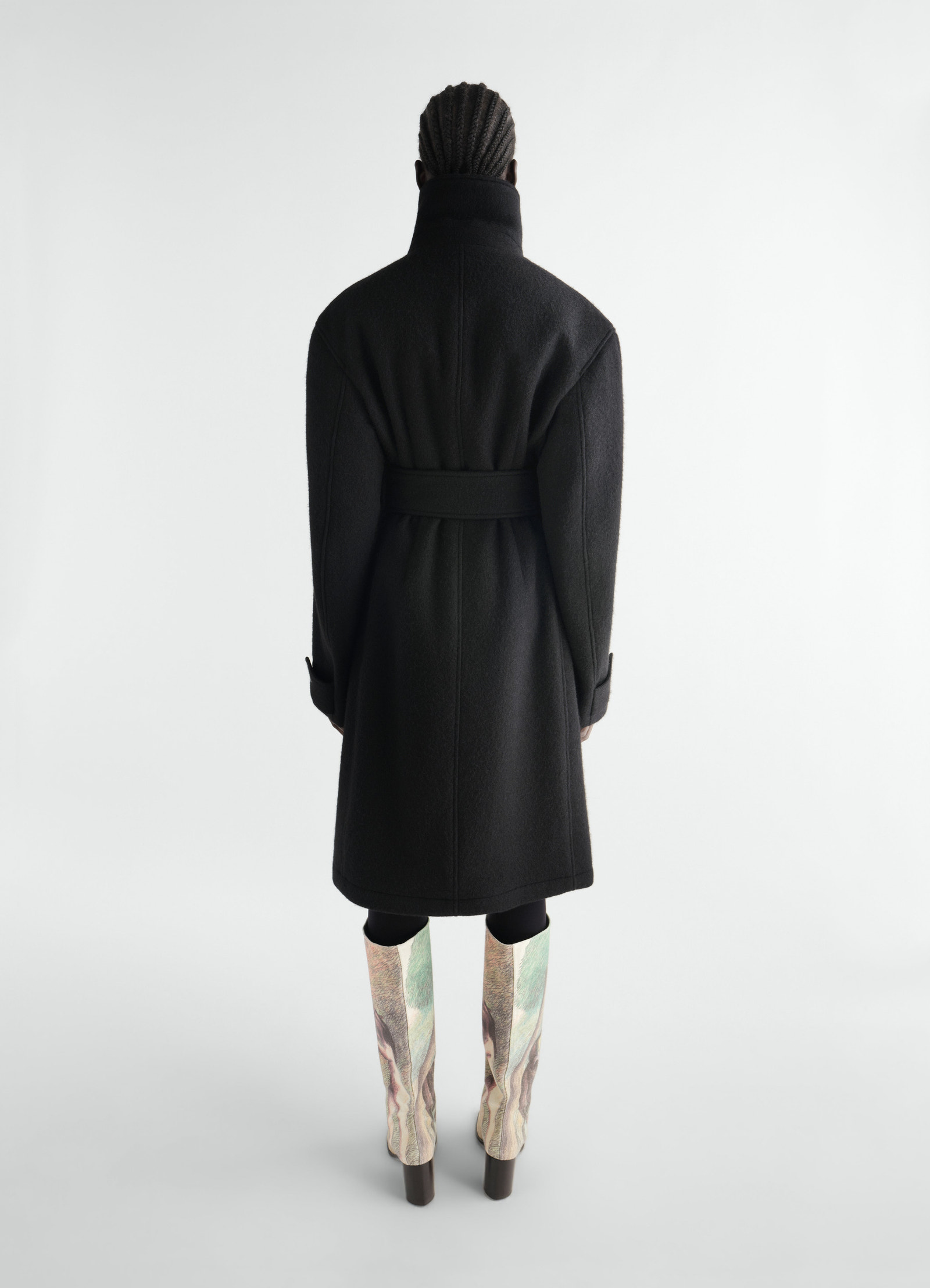 Black felted wool and alpaca blend fitted wrap coat lemaire back view worn by model with printed boots