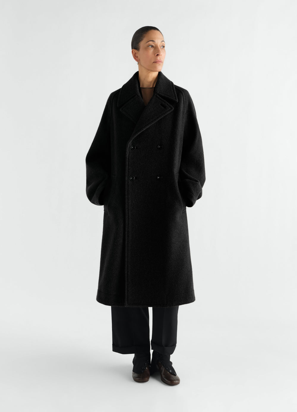 Double-breasted black felted wool and alpaca coat LEMAIRE worn by a model front view full length