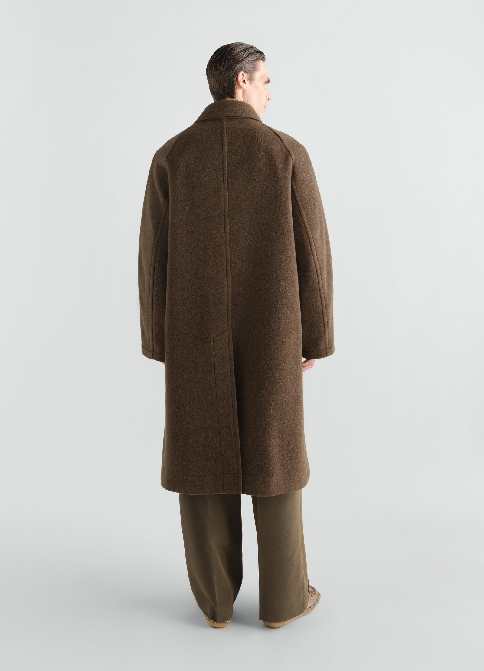 Double-breasted brown felted wool alpaca blend coat by lemaire worn by model back view