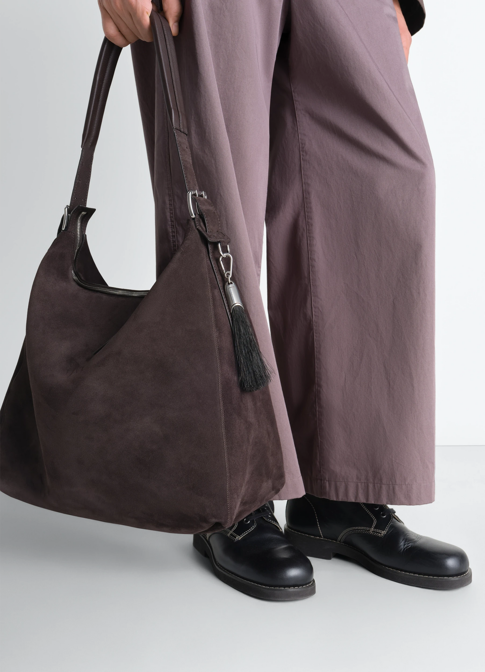 Maxi brush bag charm in horsehair, model shot, side view hanging strap detail