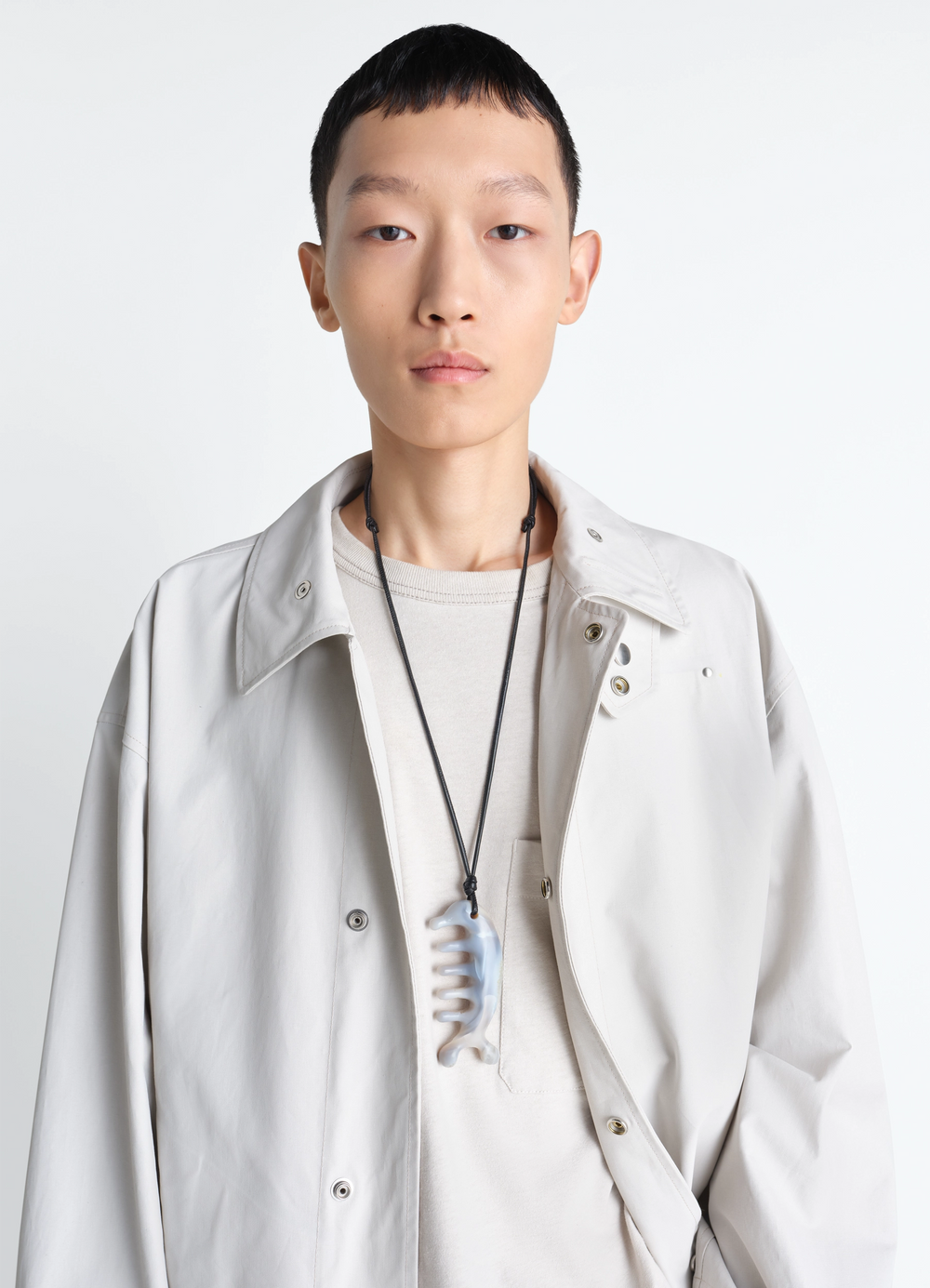 Beluga Gua Sha Necklace in Agate, model shot, portrait shot worn over neutral outfit