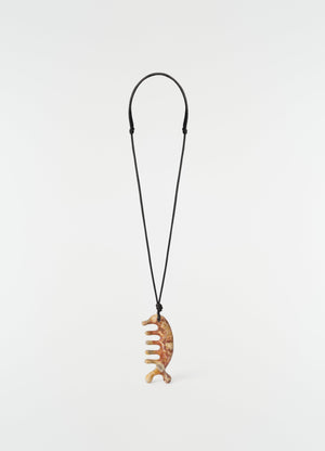 Beluga gua sha necklace in yellow jasper on black cord by lemaire on plain white background