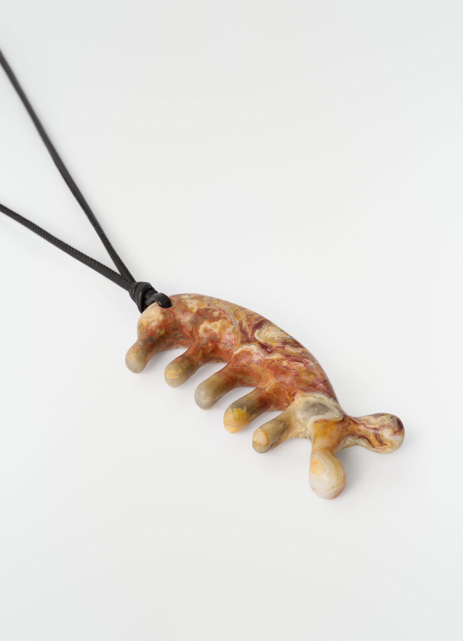 Beluga gua sha necklace by lemaire in yellow jasper stone with black cord on plain white background