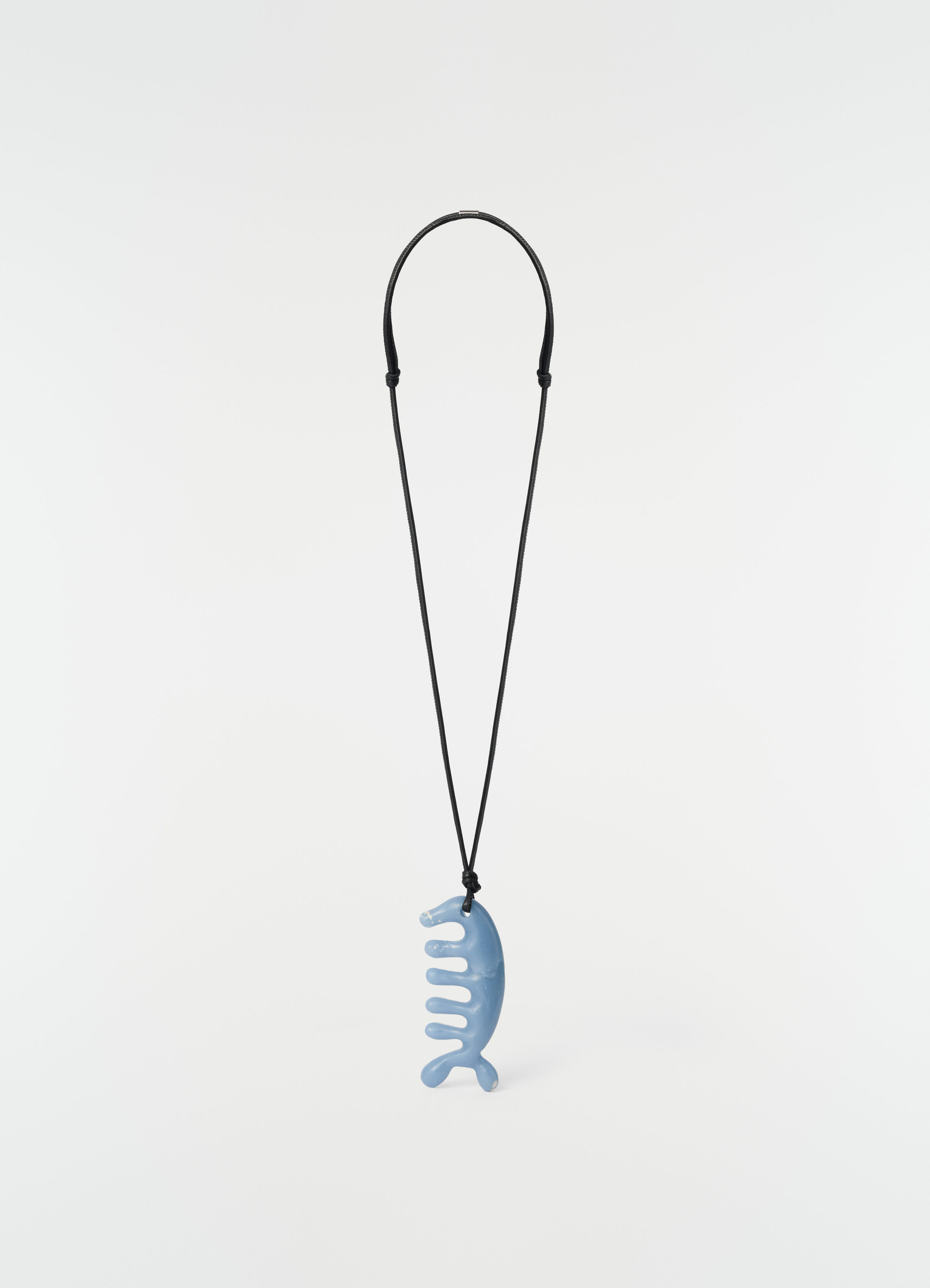 Beluga gua sha necklace in angelite blue ceramic with black cord by lemaire on plain white background