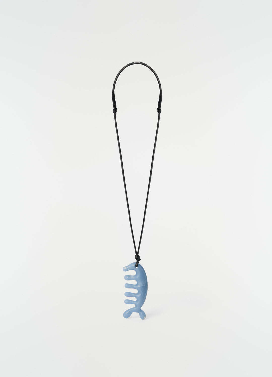 Beluga gua sha necklace in angelite blue ceramic with black cord by LEMAIRE on plain white background