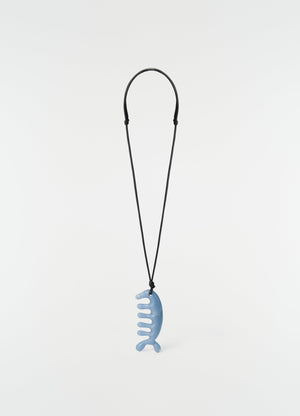 Beluga gua sha necklace in angelite blue ceramic with black cord by lemaire on plain white background