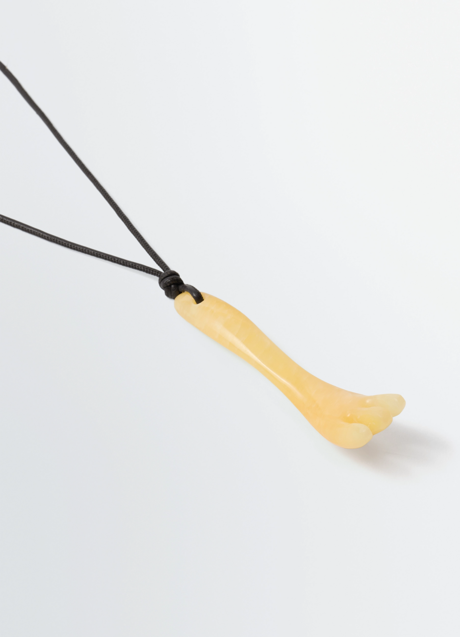 Gua sha fork necklace in aragonite, product shot, angled side view smooth polished finish