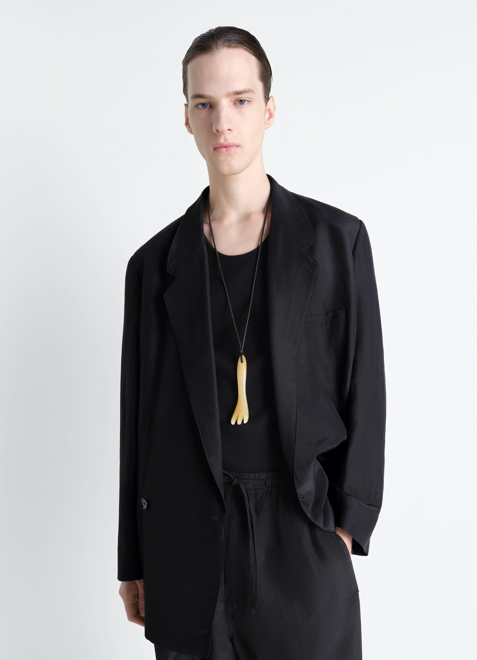 Gua sha fork necklace in aragonite, model shot, worn by model view modern unisex styling