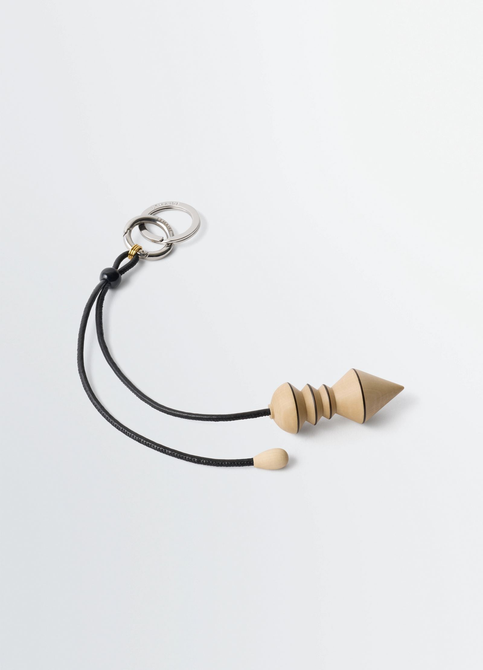 Pendulum bag charm in wood, product shot, top view double metal rings