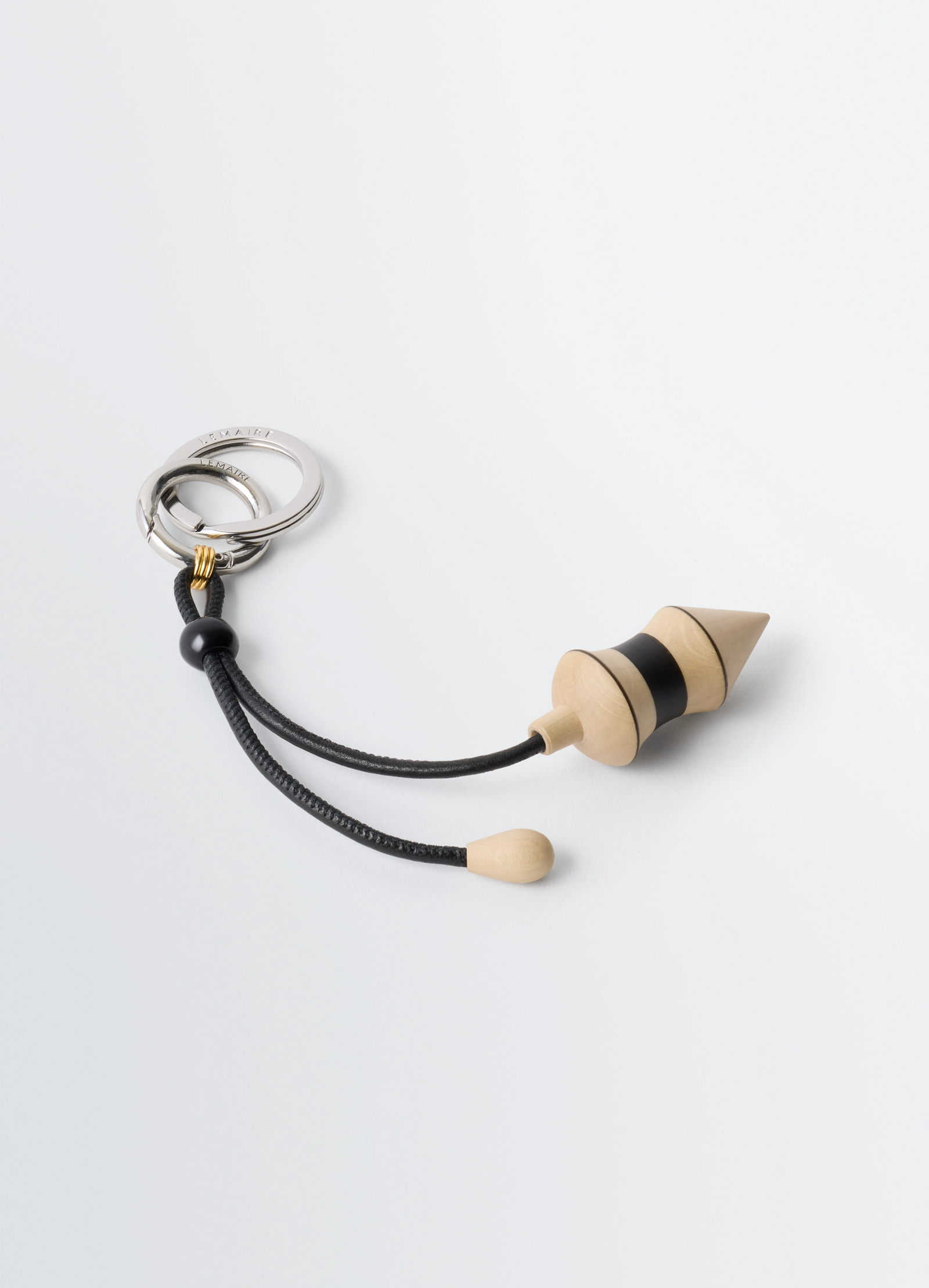 Pendulum bag charm in black stripes wood, product shot, angled top view cord detail