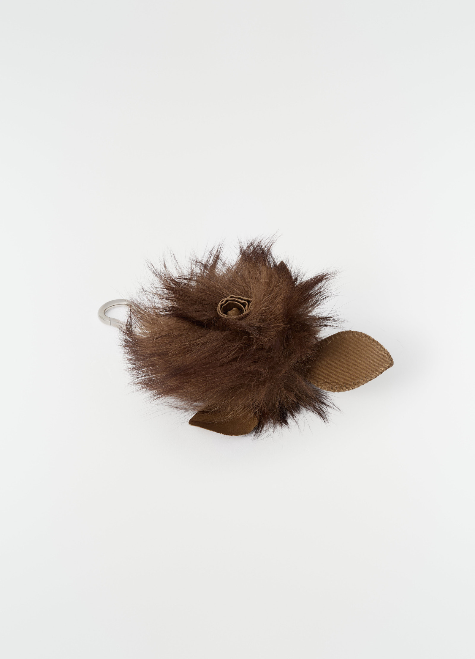Fuzzy brown rose charm in lambskin shearling with leather leaves by lemaire on plain white background
