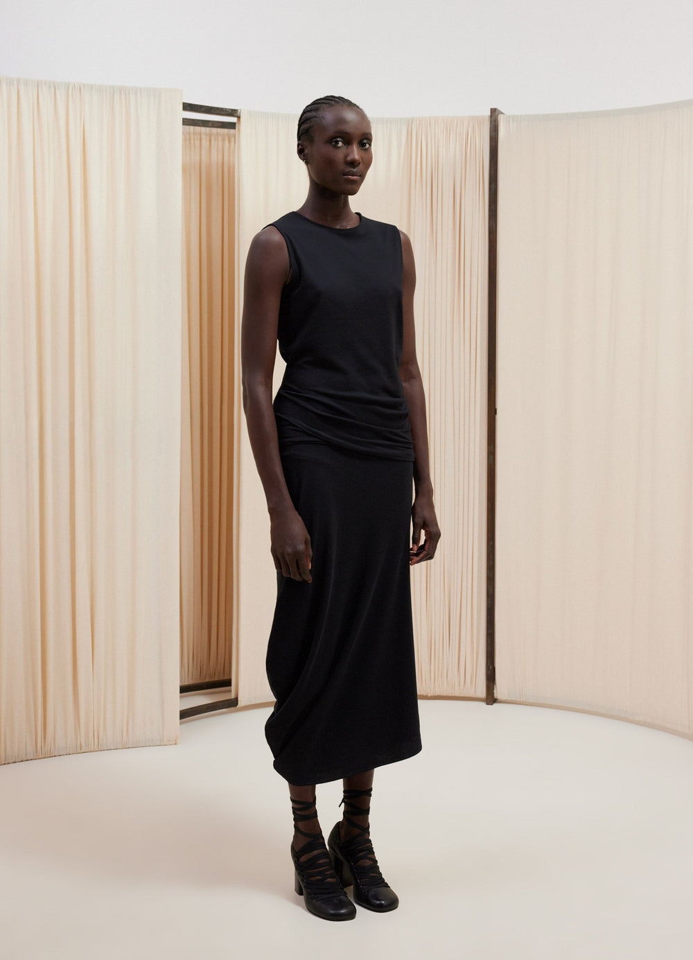Lemaire Fitted Twisted Dress in Black Light Textured Crepe Jersey, model shot, Front side view Sleeveless tube shape