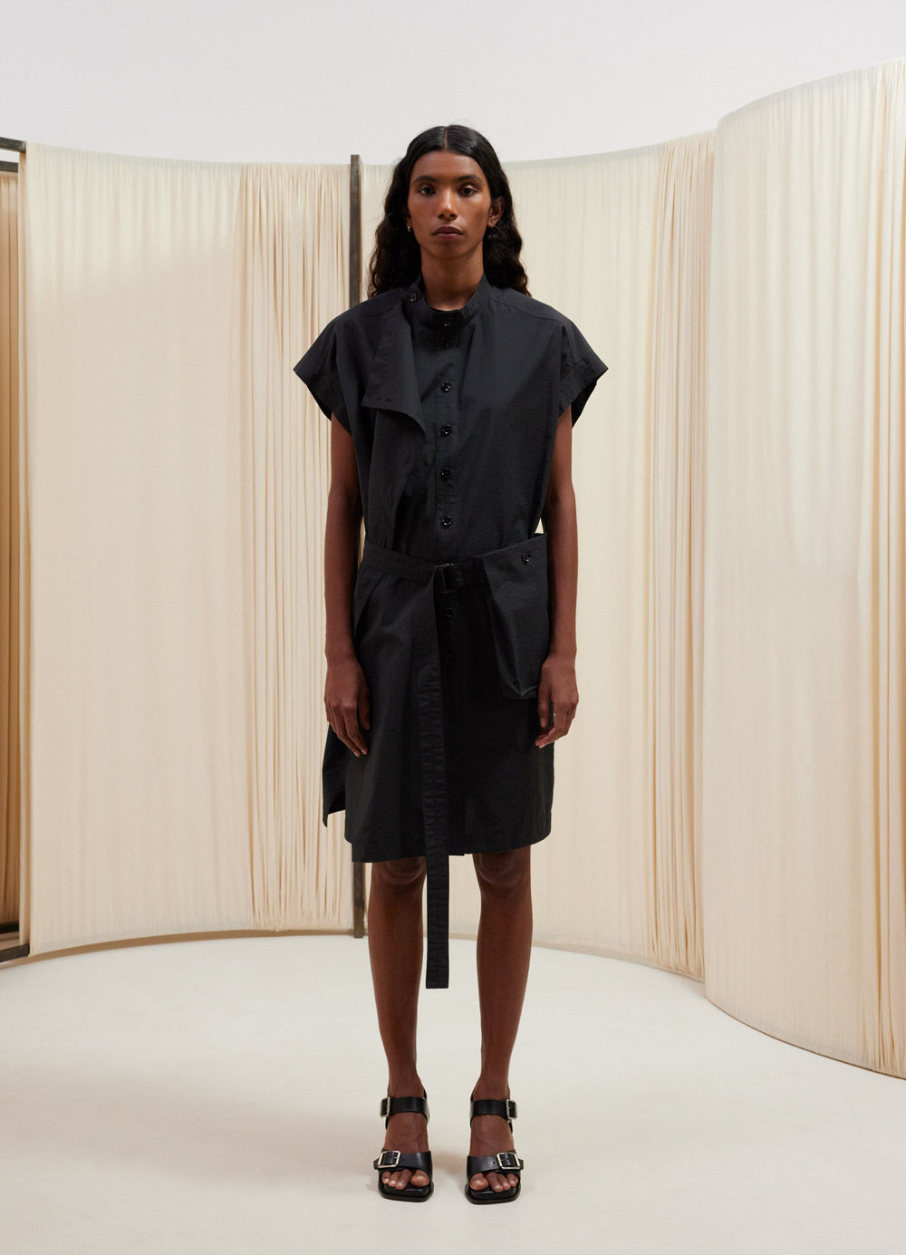 Lemaire Asymmetrical Sleeveless Dre in Black cotton nylon, model shot, Front view Draped flap, removable belt